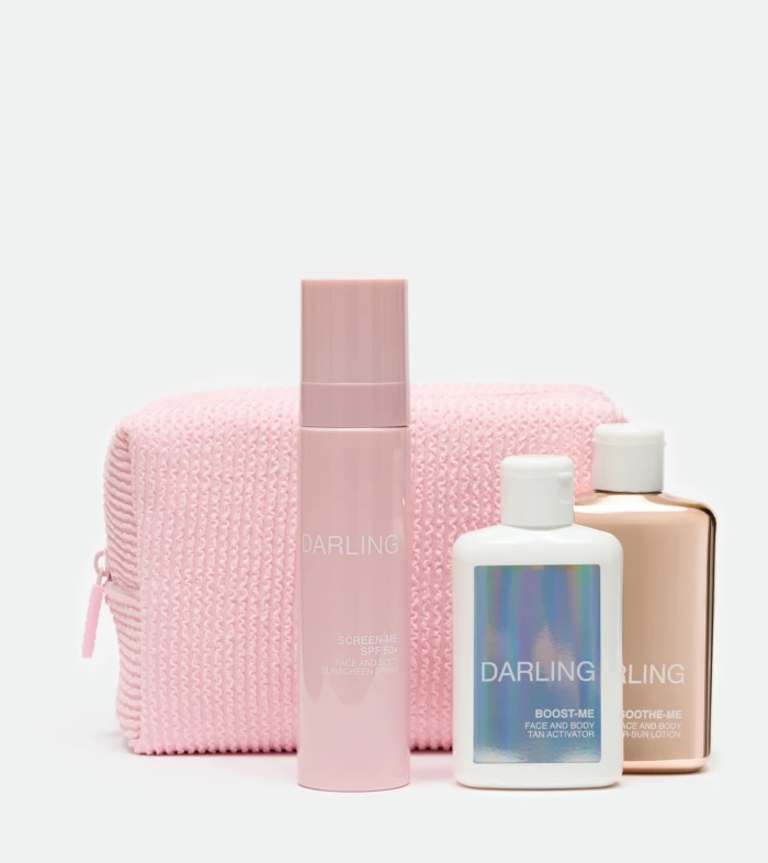 Pastel pink skincare bottles arranged in front of a pink knitted bag on a white background; marketing beauty products.