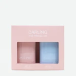 Pink travel kit box with two pastel bottles labeled DARLING, SPF 30 and SPF 50