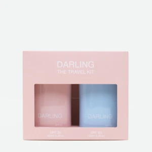 Pink travel kit box with two pastel bottles labeled DARLING, SPF 30 and SPF 50