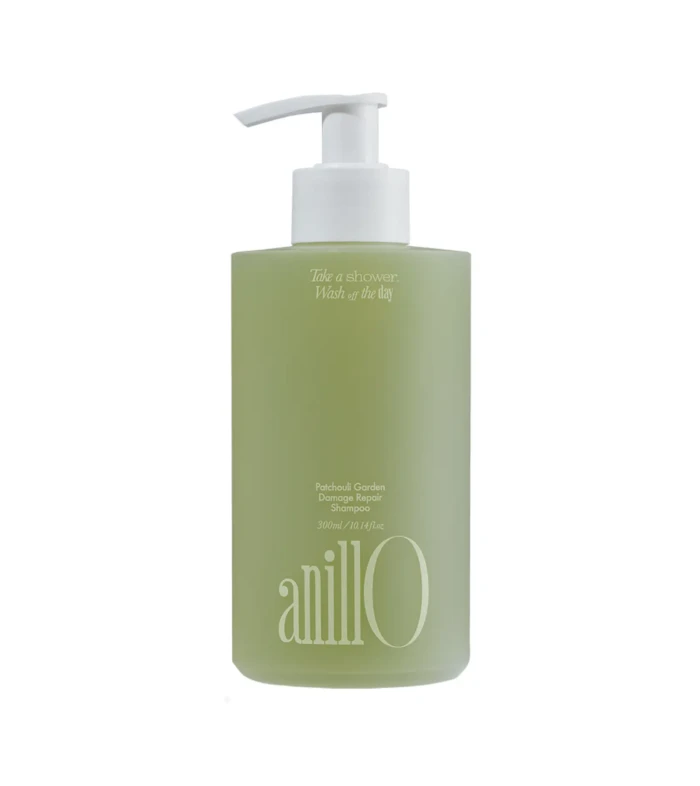 Green shampoo bottle with white pump dispenser; label reads Patchouli Garden Damage Repair Shampoo and tagline about taking a shower today (informative product image).