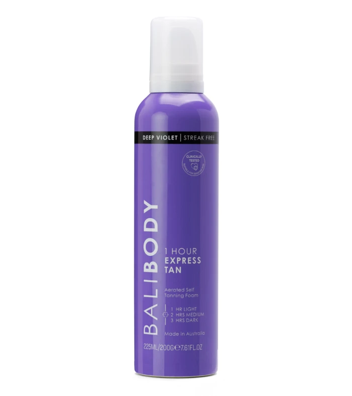 Purple spray bottle of self-tanning foam with a white cap and a black label reading 'Deep Violet' and 'Streak Free'.