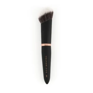 Close-up of a makeup brush with a black handle and rose-gold ferrule, bristles fanned out; 'YOUNGBLOOD' branding visible on the handle.