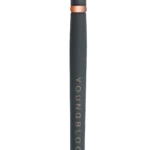 Dual-ended makeup pen with a brush tip on top and a cap at the bottom, black with rose-gold accents and 'Young Blood' branding along the side.