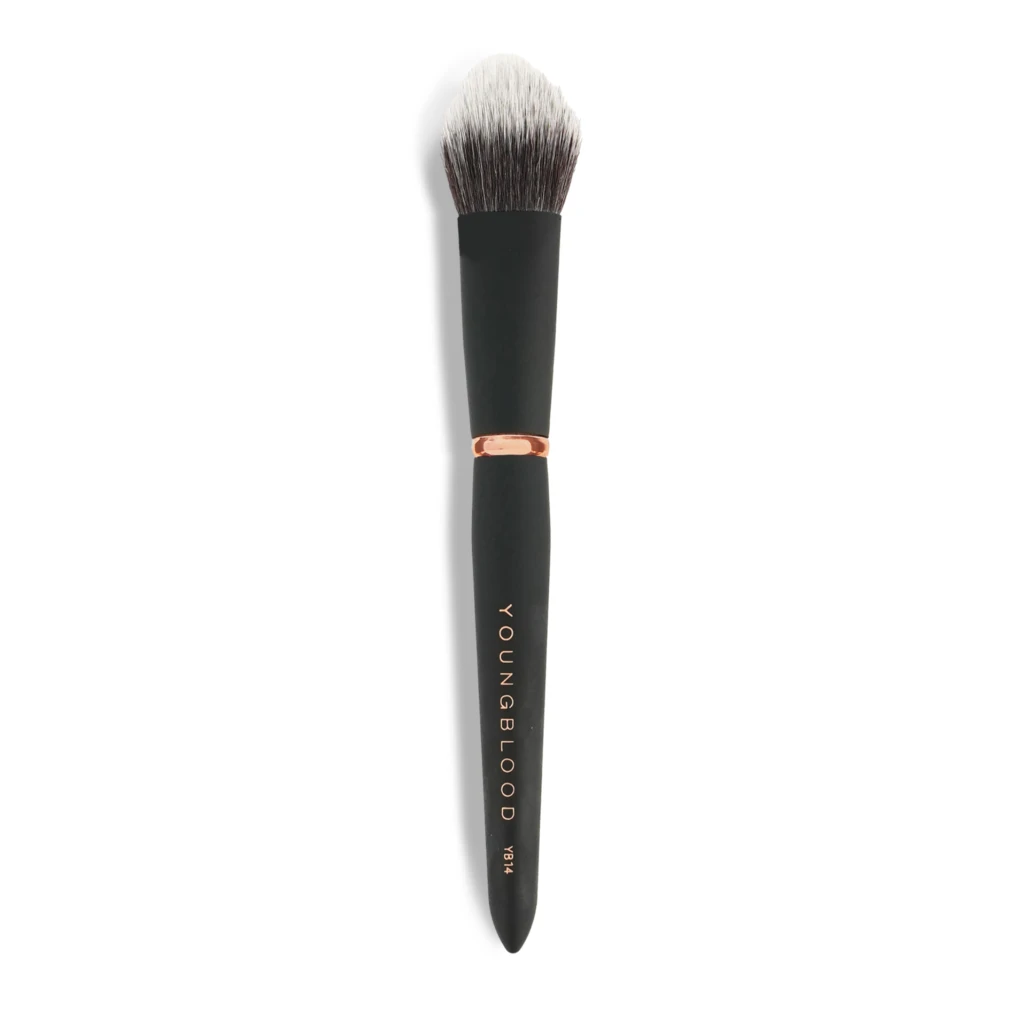 Close-up of a makeup brush with a black handle and light-to-dark bristles against a white background.