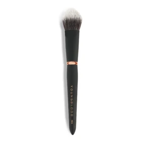 Close-up of a makeup brush with a black handle and light-to-dark bristles against a white background.