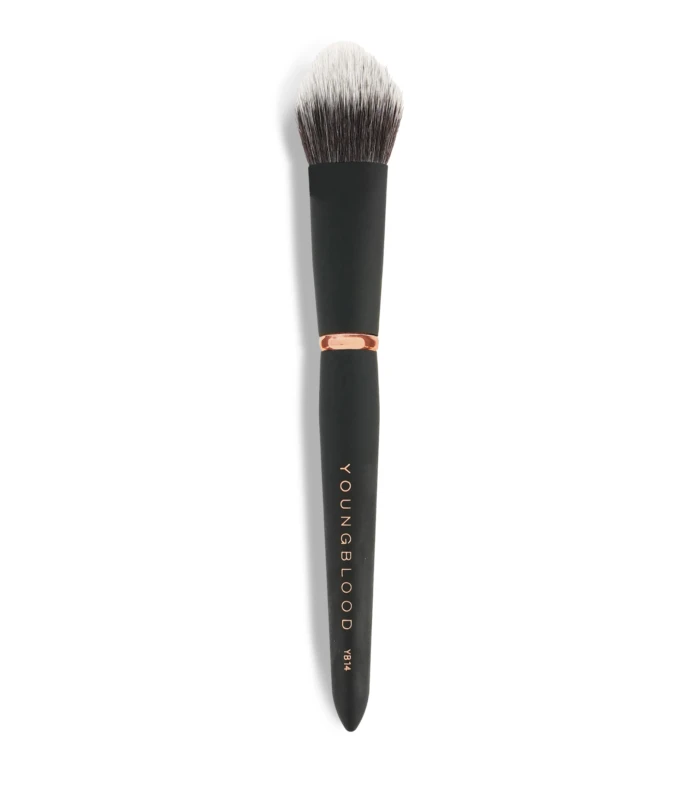 Close-up of a makeup brush with a black handle and light-to-dark bristles against a white background.
