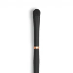 Close-up of a black makeup brush with dense bristles against a white background.
