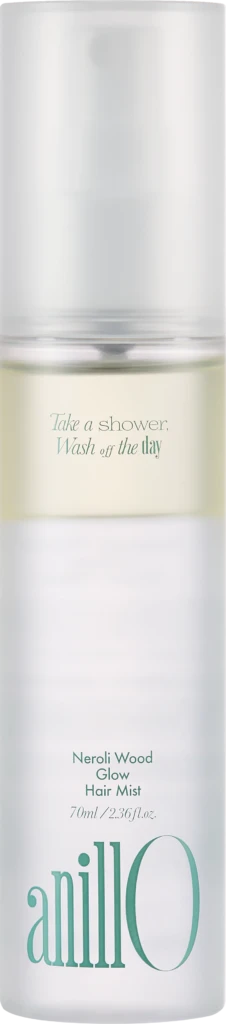 Tall white bottle with a frosted cap, labeled Neroli Wood Glow Hair Mist (70 mL) and the slogan 'Take a shower, Wash off the day'.