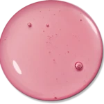 Macro shot of a pink liquid with scattered bubbles in a round, glossy container.
