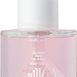 Close-up of a pink cosmetic bottle with a white cap, displaying the label 'Rosy Night Repair Hair Essence'.
