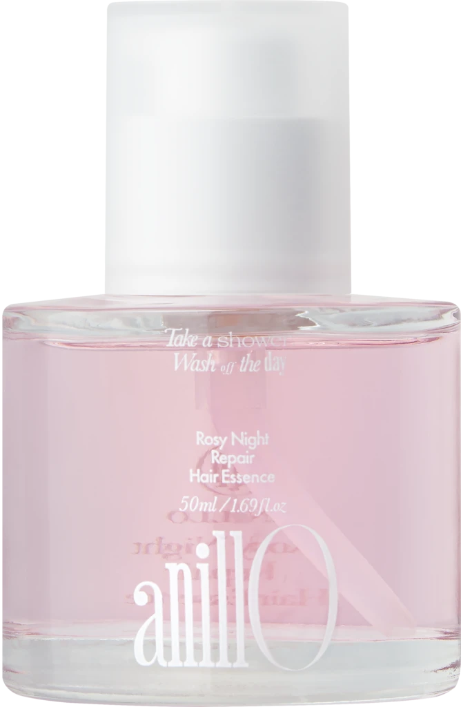 Close-up of a pink cosmetic bottle with a white cap, displaying the label 'Rosy Night Repair Hair Essence'.
