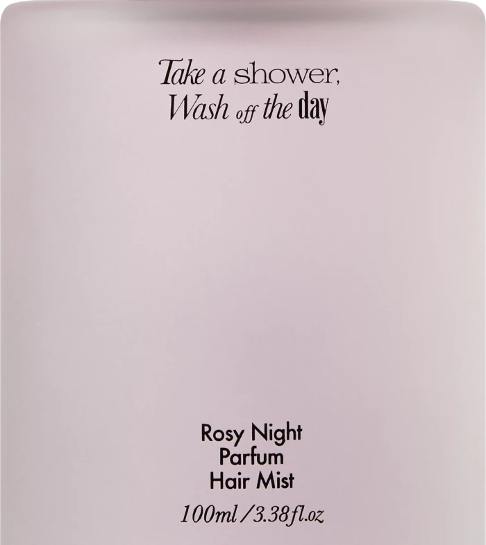 Light pink perfume bottle with a tall black cap; label reads 'Take a shower, Wash off the day' and 'Rosy Night Parfum Hair Mist, 100 ml'.