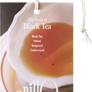 Product tag reading 'The Scent of Black Tea' with notes Black Tea, Vetiver, Bergamot, Cedarwood, attached by a rope.