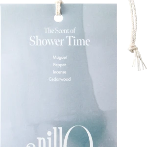 Light blue tag with white rope reading 'The Scent of Shower Time' and notes: Muguet, Pepper, Incense, Cedarwood.