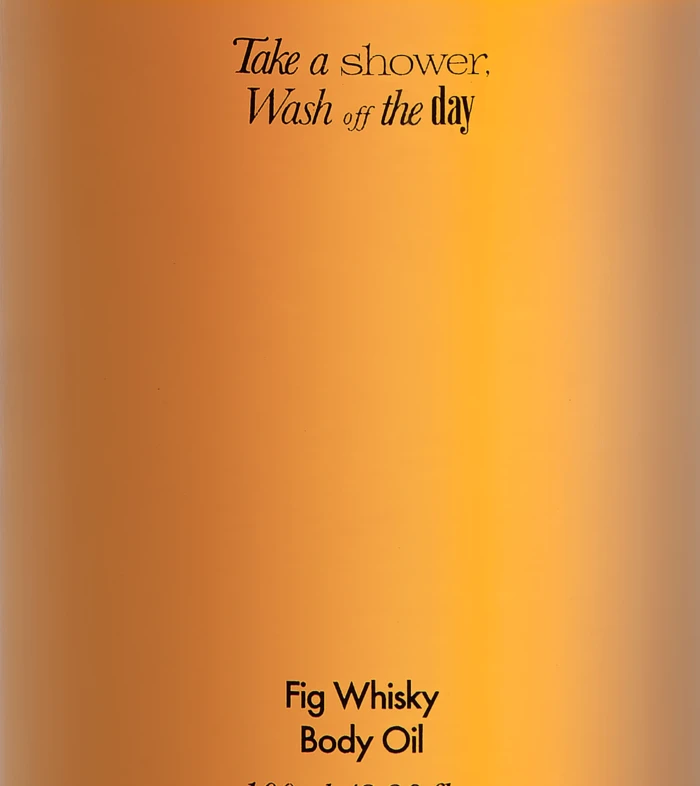 Bottle of amillO Fig Whisky Body Oil with a black cap and orange gradient label; slogan reads 'Take a shower, Wash off the day' (100 ml).