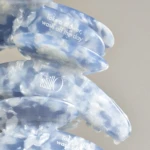 Close-up of a translucent blue plastic object with white text reading 'Take a shower, wash off the day'.