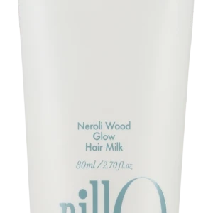 White hair milk tube labeled Neroli Wood Glow Hair Milk with blue slogan 'Take a shower, Wash off the day' and a large blue 'anillo' logo on the side.