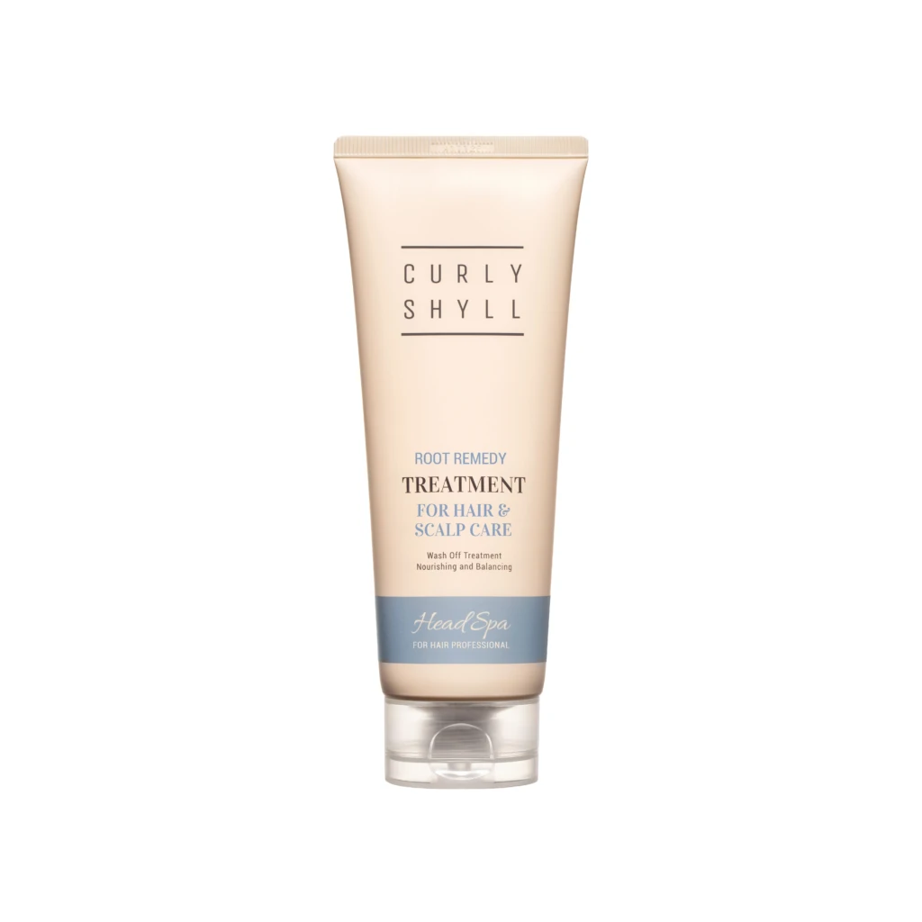 Beige tube of hair treatment standing upright with the words Curly Shyll and treatment for hair & scalp care visible on the label.