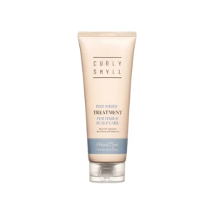 Beige tube of hair treatment standing upright with the words Curly Shyll and treatment for hair & scalp care visible on the label.