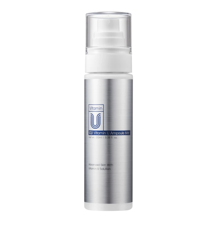 Silver cosmetic spray bottle with a clear cap, labeled 'Vitamin U Ampoule Mist,' set against a black background.