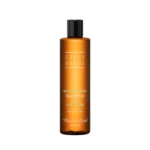 Orange shampoo bottle with a black cap, label reading 'Moisture Calming Shampoo for daily care' and brand 'Flower & Herb'.