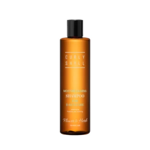Orange shampoo bottle with a black cap, label reading 'Moisture Calming Shampoo for daily care' and brand 'Flower & Herb'.