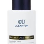 White cosmetic bottle with a dark blue dropper cap labeled 'EU CLEAN-UP' and a gold-accented band reading 'EX-C REM CALM AMPOULE' suggesting a skincare serum bottle designed for intensive care and rejuvenation, photographed against a white background.