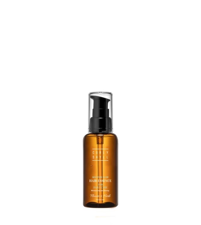 Tall amber glass spray bottle with a black pump dispenser and clear cap, showing a white label with product name 'Hair Essence' and 'Moisture Glow' text.