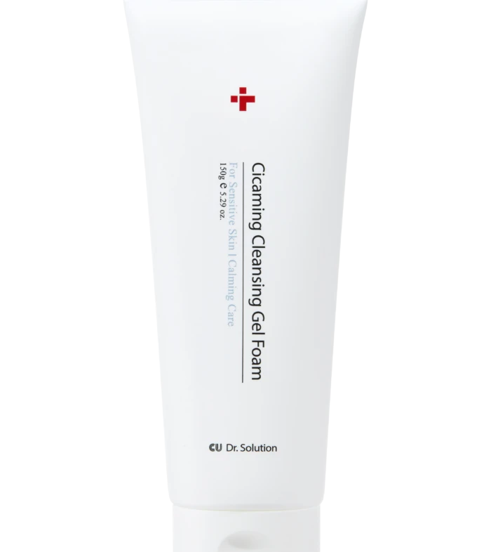 White tube of cleansing gel foam with red cross logo; label reads 'Cleansing Gel Foam' and 'For Sensitive Skin' on black background.