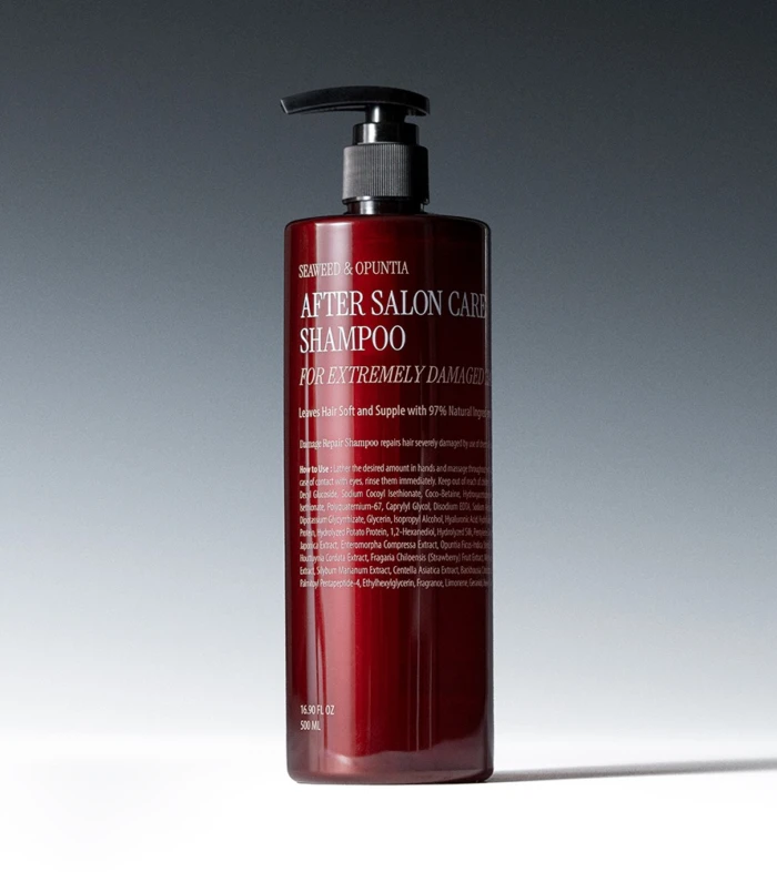 Red pump bottle of After Salon Care Shampoo with visible label on a gray gradient backdrop.