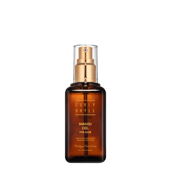 Brown glass hair product bottle with a gold spray pump and clear cap, labeled Babassu Oil for Hair in gold lettering.
