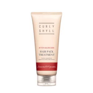 Tube of hair treatment product labeled Curly Shyll with 'After Salon Care' and 'Hair Pack Treatment' text in a pale pink container against a light background.