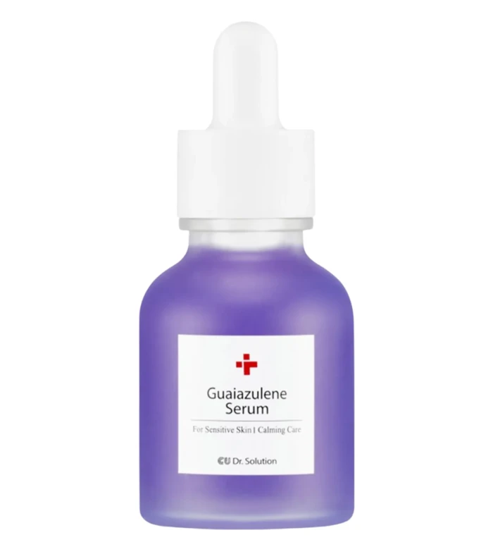 Purple glass serum bottle with a white dropper cap and label reading 'Guaiazulene Serum'
