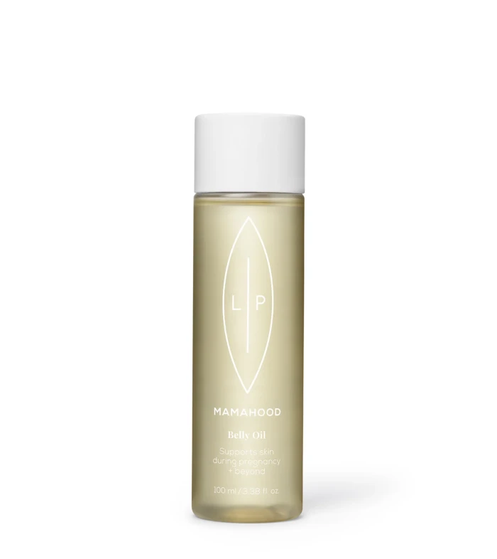 Bottle of Mamahood Belly Oil with white cap, beige oil visible through glass, text/logo along the label indicating product name and用途.