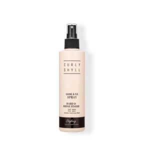 Beige hair styling spray bottle labeled Curly Shyll with a black nozzle cap.