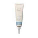 Cream-colored squeeze tube labeled HeadSpa with 'Purifying Scalp for normal & oily scalp' text and a blue bottom band.