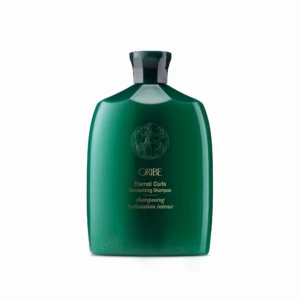 Green plastic bottle of Oribe Eternal Curls Moisturizing Shampoo, front view with embossed logo and gold text.