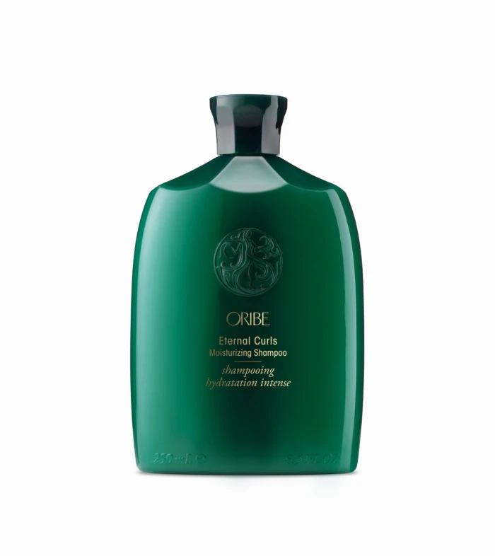 Green plastic bottle of Oribe Eternal Curls Moisturizing Shampoo, front view with embossed logo and gold text.