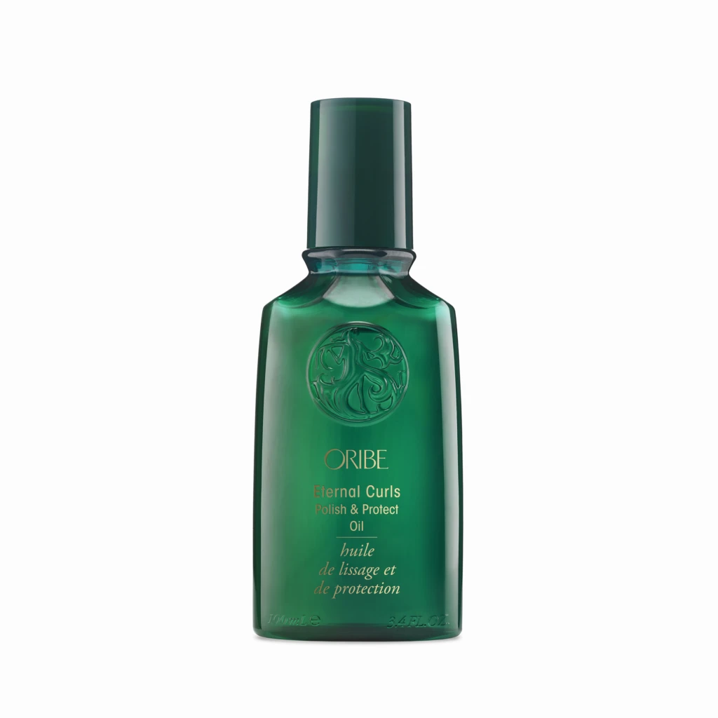Close-up of a tall, dark green bottle with a long neck against a white background; embossed emblem on the front.