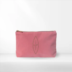 Pink zippered pouch with gold zipper on a white background, featuring a gold leaf-shaped emblem with the initials LP.