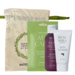 Hair care travel kit: canvas pouch with green strap plus green packaging and three products (shampoo, conditioner, leave-in treatment) arranged in front.