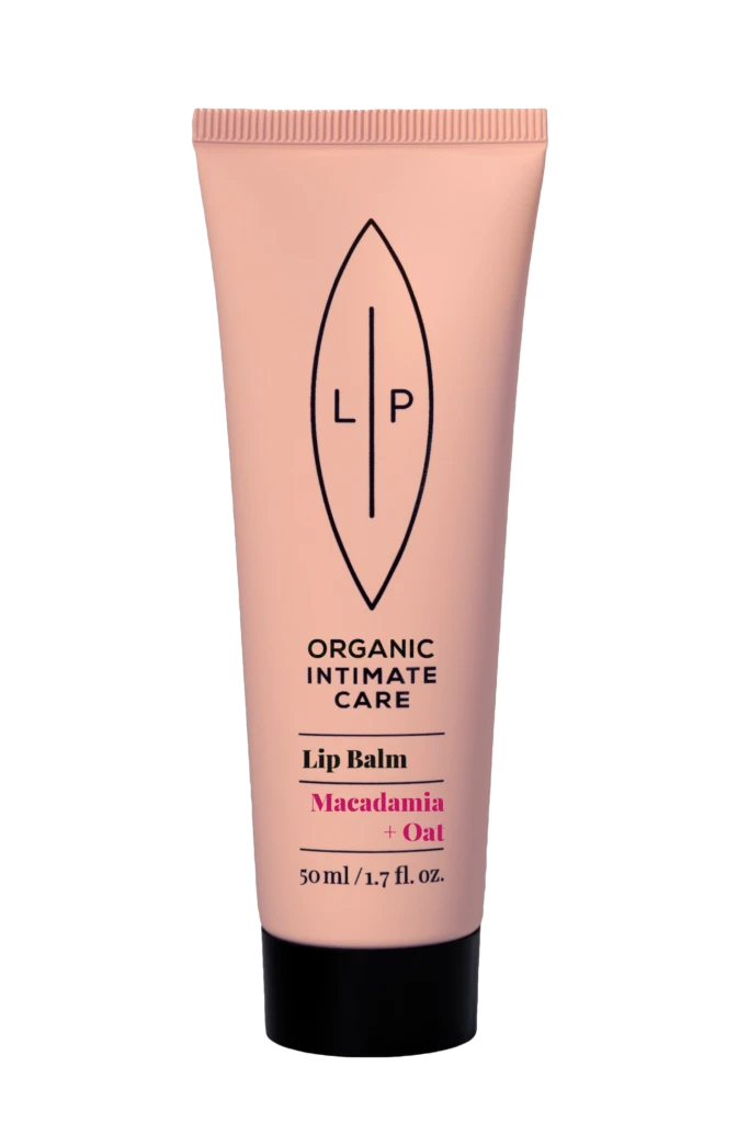 Pink lip balm tube with black cap, logo and product name visible: Organic Intimate Care Lip Balm in Macadamia + Oat, 50 ml/1.7 oz