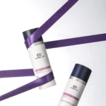 Cosmetic tubes wrapped in diagonal purple ribbons in a minimalist white setting, emphasizing product branding and color contrast