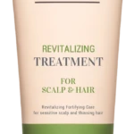 Beige tube of Curly Shyll revitalizing treatment for scalp and hair with a green Citrus Tea Tree band and beige cap.