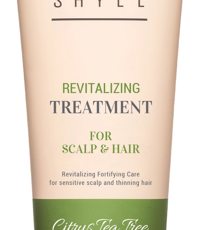 Beige tube of Curly Shyll revitalizing treatment for scalp and hair with a green Citrus Tea Tree band and beige cap.