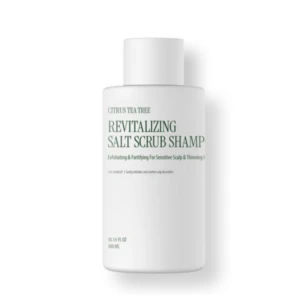 White bottle labeled "Revitalizing Salt Scrub Shampoo" with Citrus Tea Tree on a white background, cosmetic product.